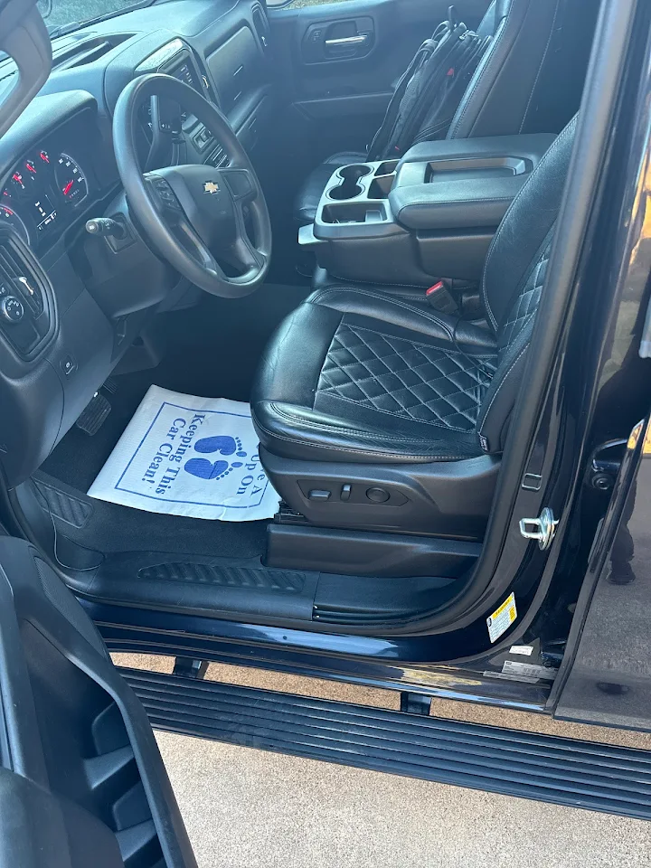 Professional interior car detailing showing clean leather seats and dashboard at Auto Bath Car Wash Arlington